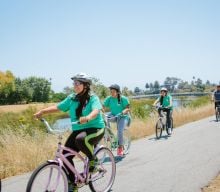 Youth Biking Along River