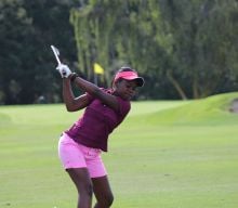 Girl taking a swing on the golf course