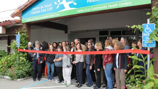 A large group of people gathered for a ribbon-cutting ceremony outside the new East Cliff Family Health Clinic.